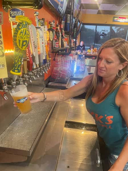 Bartender pouring ice cold beer