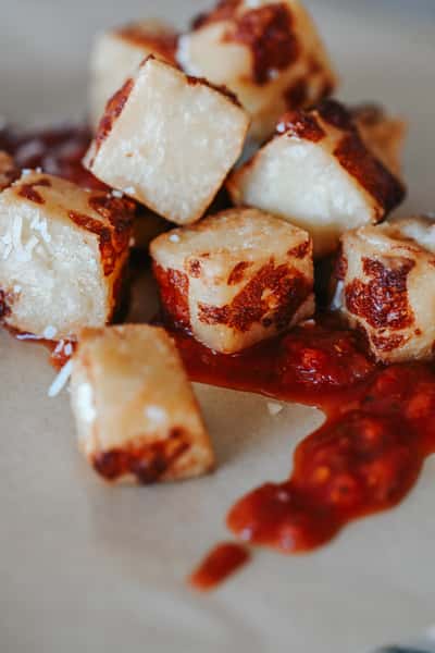 Golden fried cheese curds with melty cheese centers served as a classic pub-style appetizer.