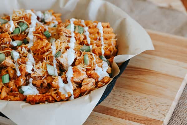 Crispy waffle fries layered with chopped chicken, creamy ranch sauce, shredded cheese, and fresh scallions.