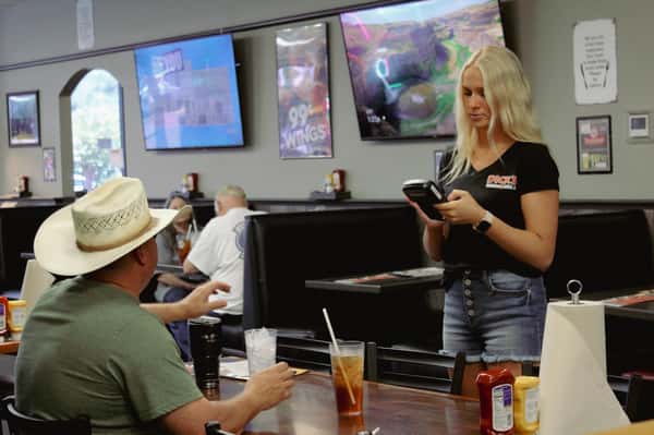 Dick's Wings & Grill Starke server talking to guest