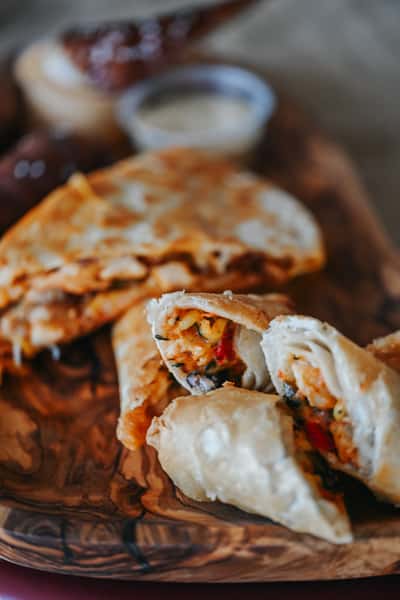 Selection of shareable appetizers including quesadilla wedges, Southwest egg rolls, and crispy fried favorites.