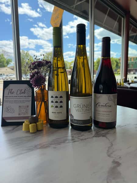 Premium wine bottles displayed on a restaurant table with scenic window views and elegant dining ambiance