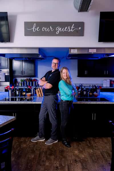 Couple posing together inside a modern restaurant lounge with stylish nightlife and bar atmosphere