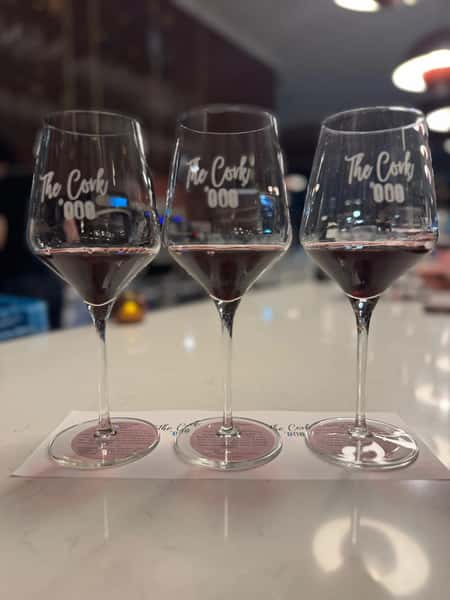 Elegant wine glasses with etched lettering displayed at an upscale restaurant tasting event or wine bar