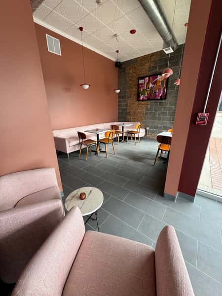 Modern upscale restaurant lounge with plush seating, warm lighting, and contemporary dining atmosphere