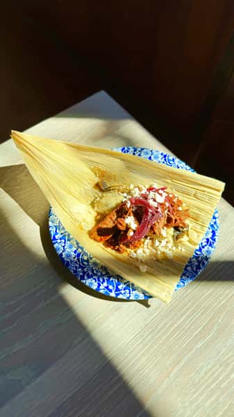 Collard green tamale with chili con carne