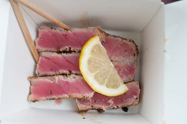 A side of tuna with lemon.