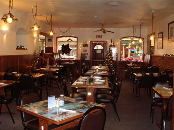 Indoor dining area with Christmas tree in the background