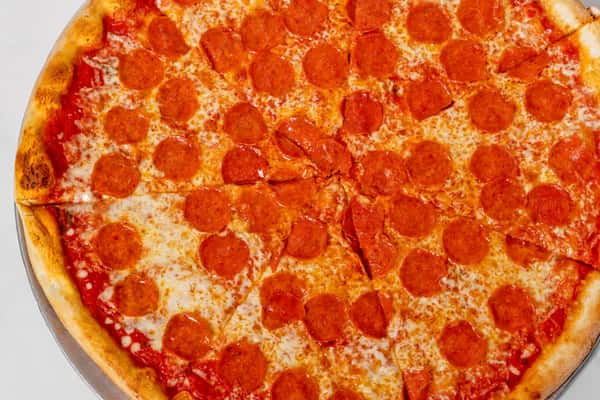 close up of pepperoni pizza with melted cheese and crispy crust on a round pie