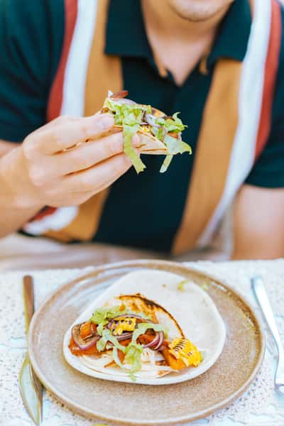 person eating fish taco