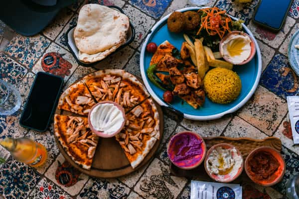a-vibrant-display-of-middle-eastern-dishes-with-pizza-and-co