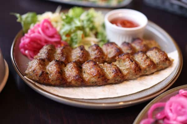 grilled-kebab-served-with-pickled-onions-and-a-fresh-side