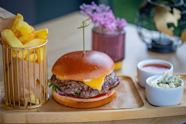 delicious-gourmet-cheeseburger-served-with-fries-and-dips-on