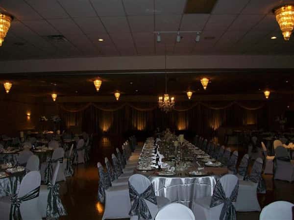 Tables and chairs setup for an event with ribbons