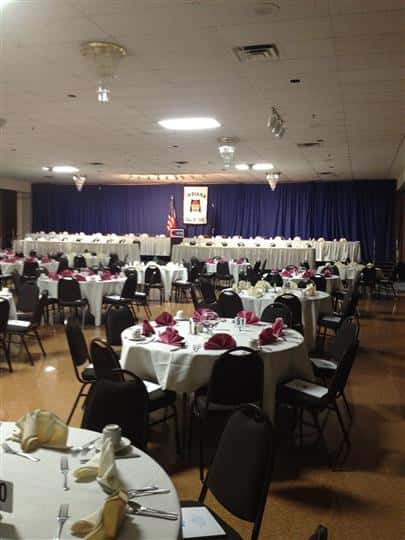 Tables and chairs set up with stage in the front
