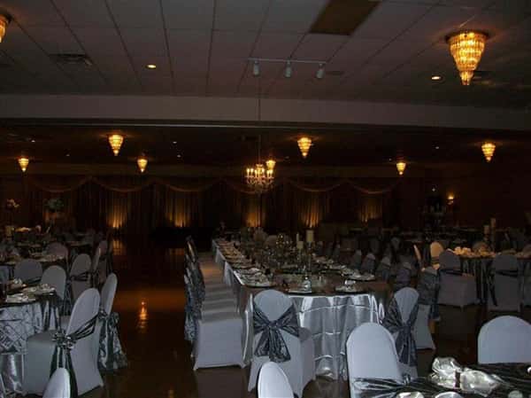 Tables and chairs setup for an event with ribbons