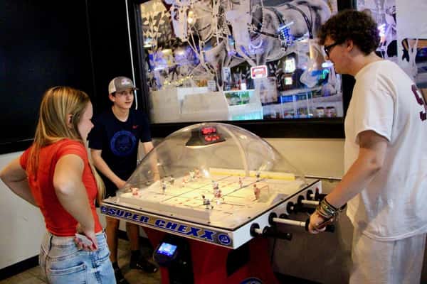 Family playing arcade hockey