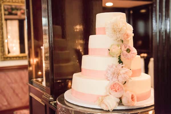 beautiful four-tiered white and pink wedding cake