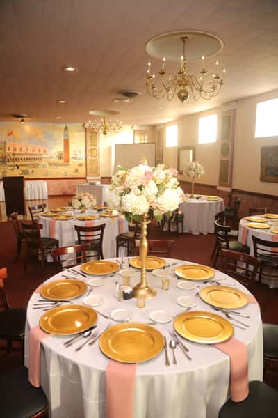 reception room with round banquet tables and tall bouquet centerpieces