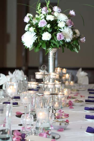 table set for banquet with tall floral centerpiece