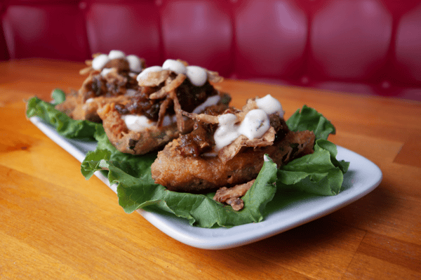 crispy jalapeño poppers with creamy drizzle on greens at Smith's Olde Bar Atlanta casual American bar food
