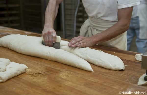 Baker cutting dough