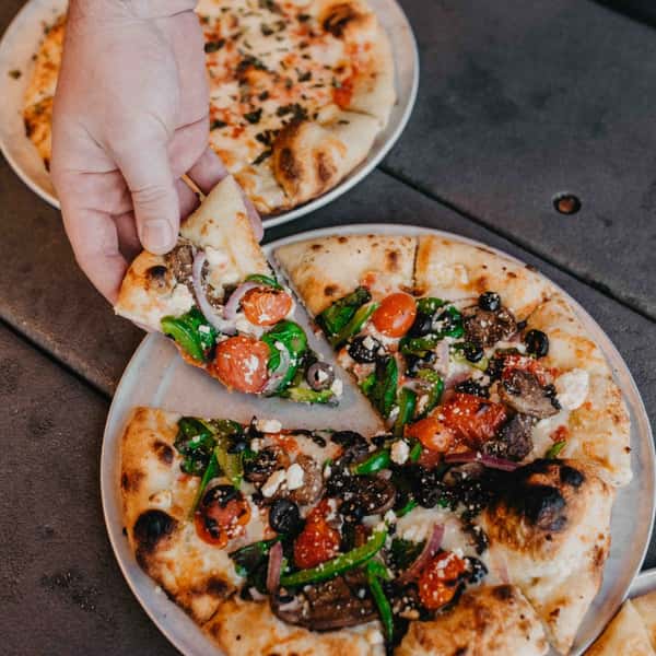 pizza with hand grabbing