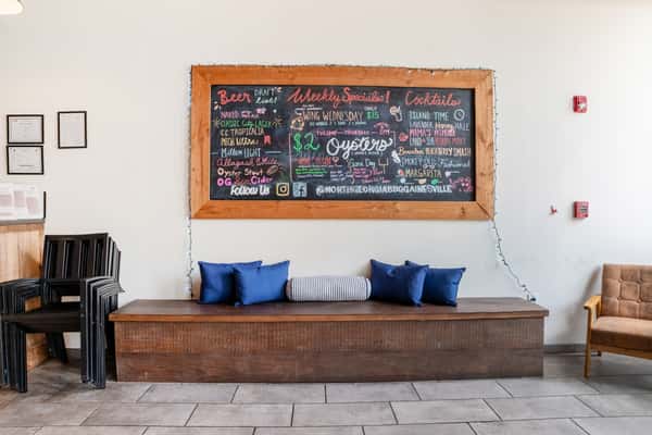 Cozy seating area inside North Georgia BBQ featuring rustic decor and menu board