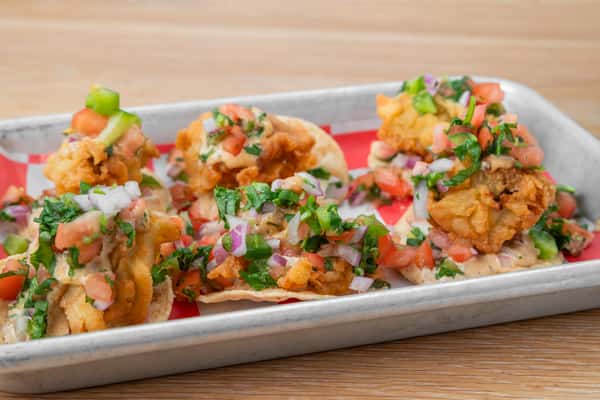 Pearl Nachos topped with barbecue meat, pico de gallo, cheese, and jalapeños at North Georgia BBQ