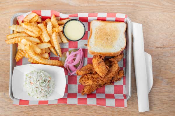 Crispy chicken finger plate with fries, coleslaw, Texas toast, and dipping sauce at North Georgia BBQ
