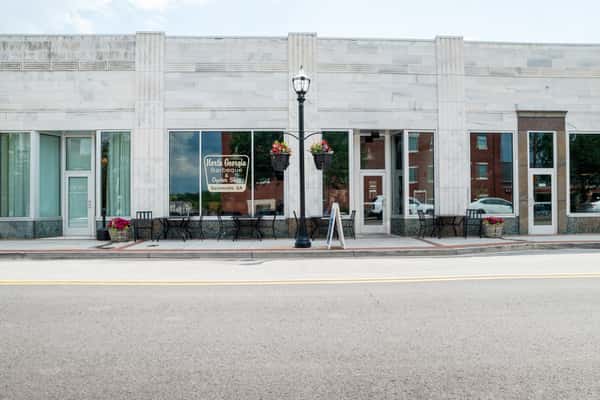 Exterior view of North Georgia BBQ restaurant showing the white commercial building facade with large windows and outdoor scenery