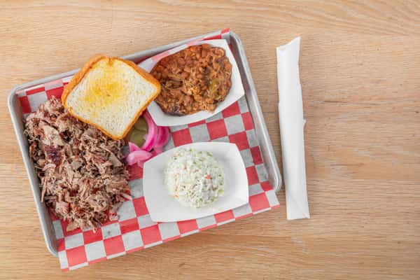 Chopped pork barbecue plate with baked beans, coleslaw, Texas toast, and pickled onions at North Georgia BBQ