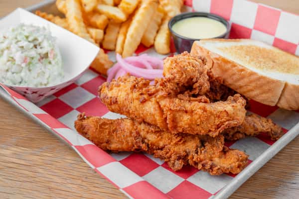 Crispy chicken finger plate with fries, coleslaw, Texas toast, and dipping sauce at North Georgia BBQ