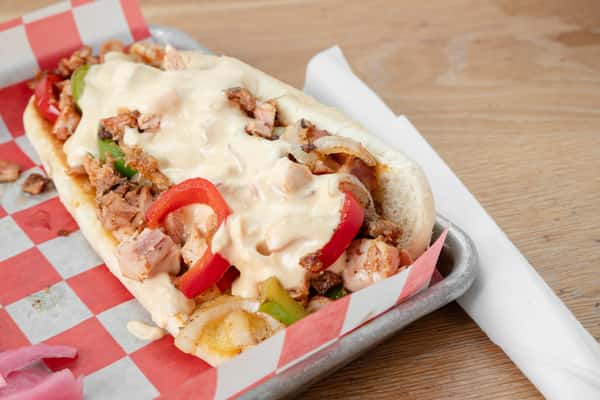 Chicken philly sandwich with peppers, onions, and melted cheese served in a metal tray at North Georgia BBQ restaurant