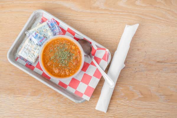 Takeout Brunswick stew served hot with crackers at North Georgia BBQ restaurant