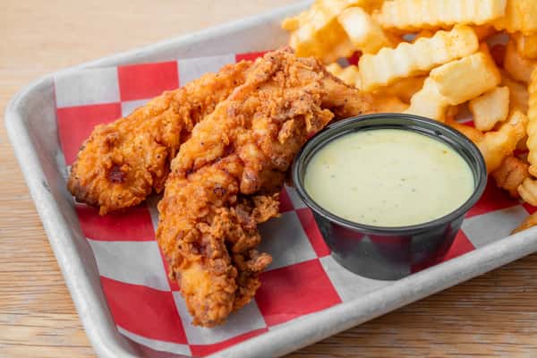 Kid's chicken fingers served with crinkle-cut french fries and dipping sauce in a metal tray at North Georgia BBQ restaurant