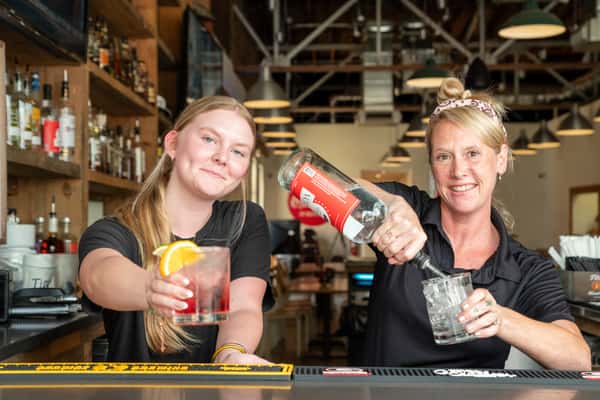 Friendly staff preparing beverages behind the bar at North Georgia BBQ restaurant