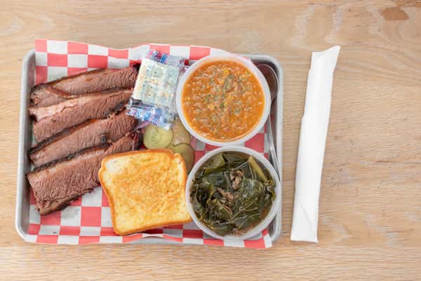 Smoked brisket barbecue plate with Brunswick stew, collard greens, and Texas toast at North Georgia BBQ