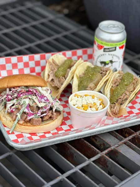 Pulled pork tacos with green salsa served with a barbecue sandwich and street corn in a casual Southern BBQ setting