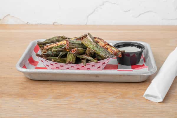 Fried okra served on a white plate with a small dark dipping sauce bowl at North Georgia BBQ restaurant