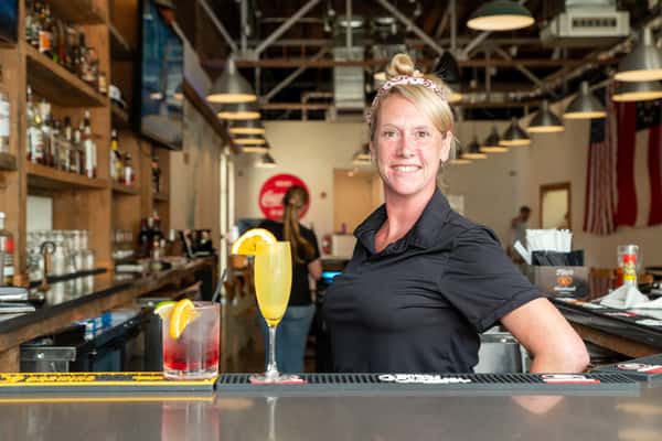 A staff member in a black shirt at North Georgia BBQ restaurant