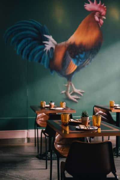 Interior of restaurant with rooster wall paper