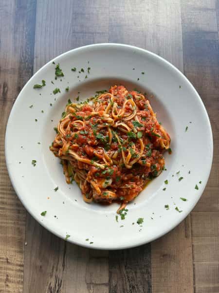 Lobster and shrimp sauteed in a spicy tomato sauce and tossed with pasta