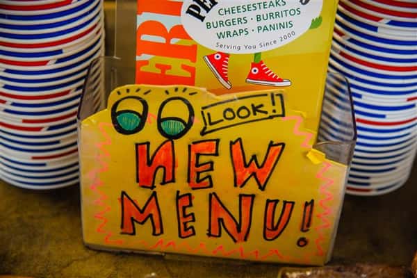 Photo of a Sign with the inscription "Look New Menu!"