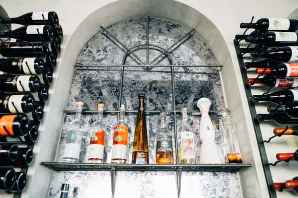 Interior window with different wine bottles surrounding it on racks