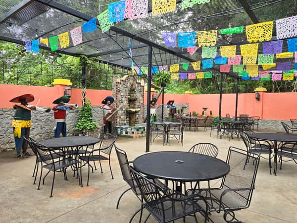 outdoor seating area paper flags and stone fountain