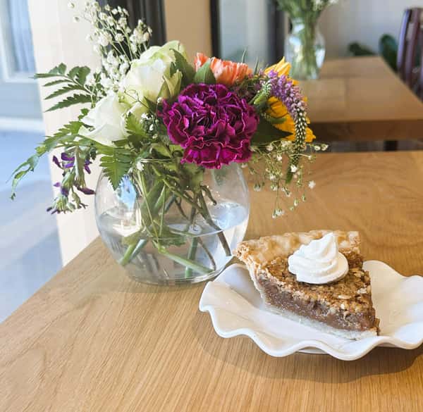 Crushed pecans nestled in a rich, caramel‑kissed custard, all cradled in a flaky, buttery crust
