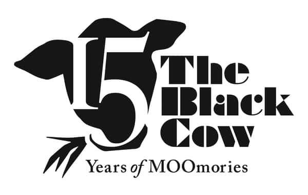 Logo celebrating "The Black Cow" restaurant's 15th anniversary. A cow silhouette contains the number 15, accompanied by the text "The Black Cow" and "Years of MOOmories".