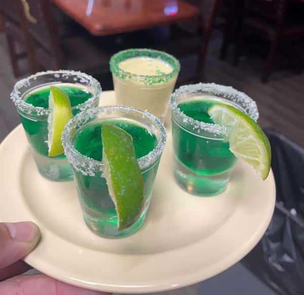four shot glasses on a plate