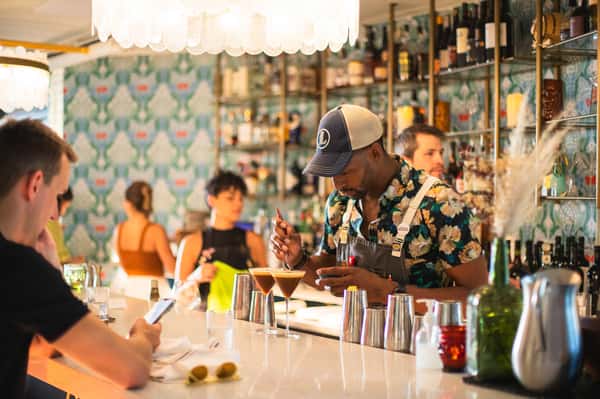 Interior bar with employees mixing drinks